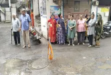 Residents put up BJP flag in drain water in protest