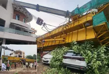 Surat metro project’s crane topples, damages building, cars