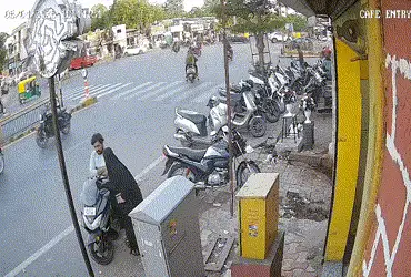 AMTS bus collides with two girls on two-wheeler riding wrong side, CCTV footage surfaces