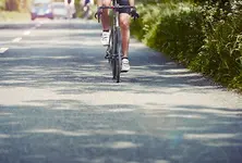 Cyclist suffers minor injuries after car overturns following collision with divider